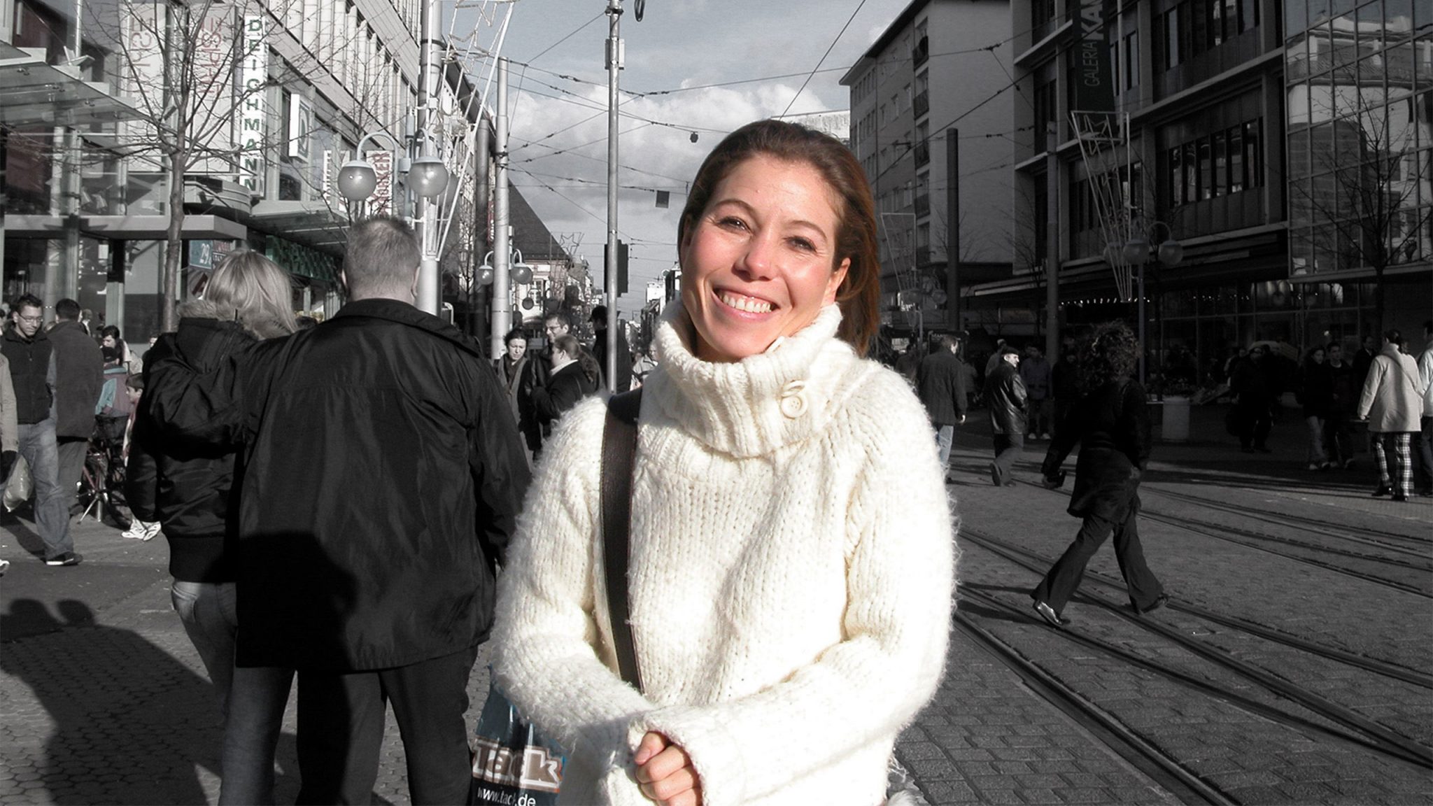 Smiling lady set among busy street of an industrial German City. Used for "InterBe" – a Mental Health Charity publicity