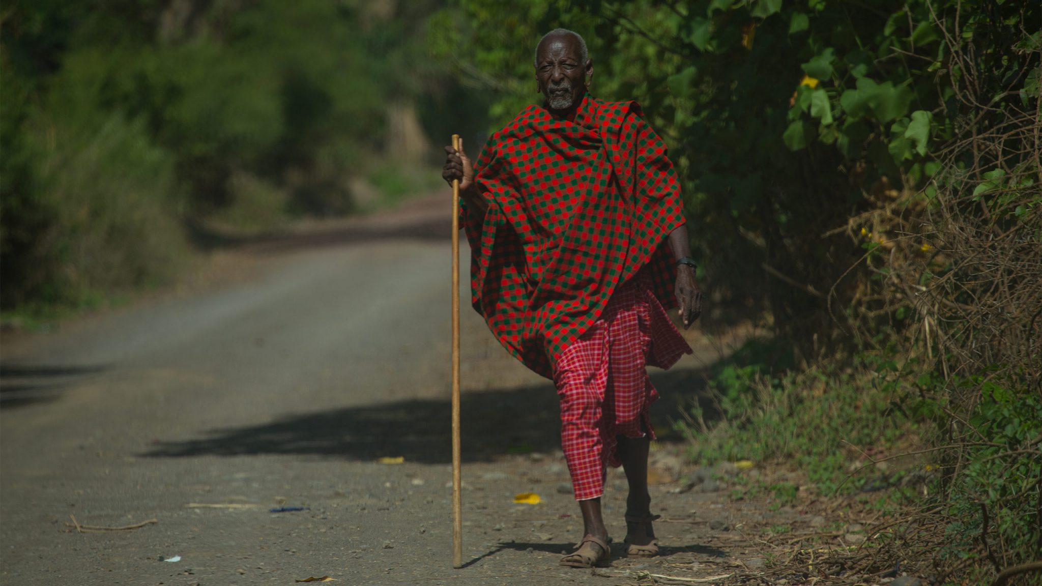 On the outskirts of Monduli village I captured the walk of a village elder as he approaches the outskirts. A most common sight during your travels, you’ll see all members of society walking. Even in the baking midday sun, its easy to understand why they’ve developed their distinctive clothing to suit their environment, as it seems to offer both protection against the sun and flamboyance and colour. Although it was rare to see a Maasai wearing a hat.